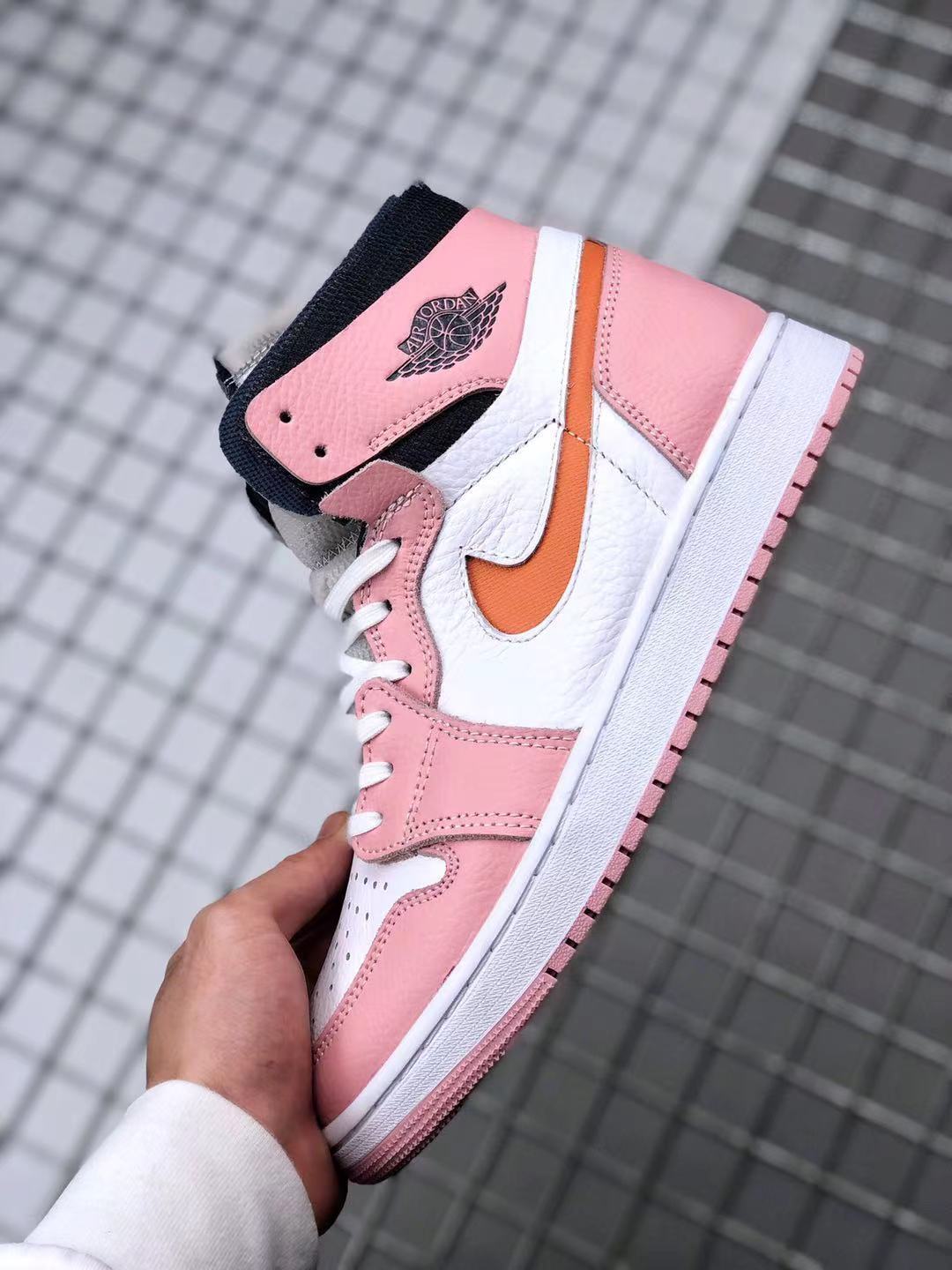 Side profile showing the high-top collar, Jordan branding, white mid-panel, and pink outsole.