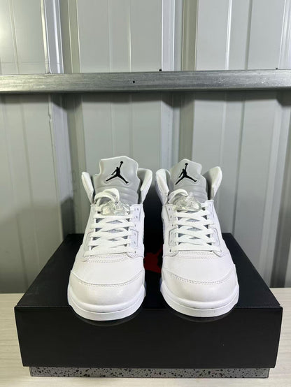 Front view of the pair showing white uppers, lace-up construction, and tongue branding.