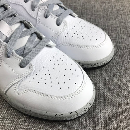 Close-up of the white perforated toe boxes, grey laces, stitching, and speckled midsole.