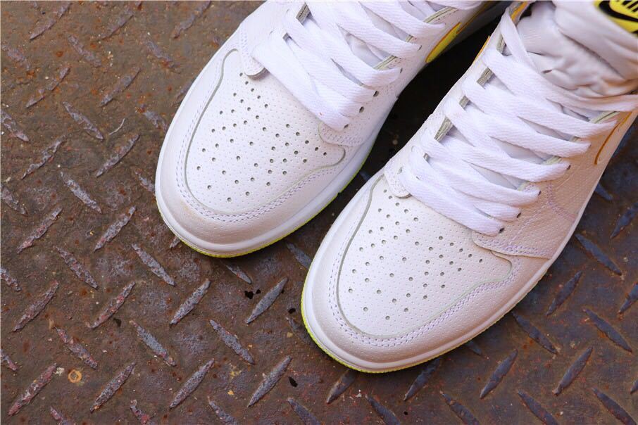 Close-up of the perforated white toe boxes and white laces.