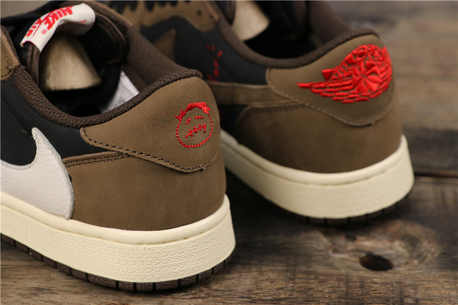 Close-up of the dark mocha heel panels with red embroidered heel graphics and cream-colored midsoles.