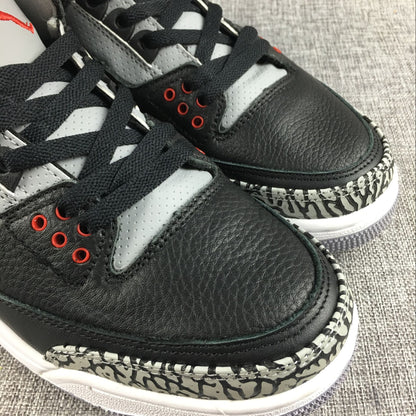 Close-up of black toe panels, grey perforated lace panels, red eyelets, and elephant-print trim