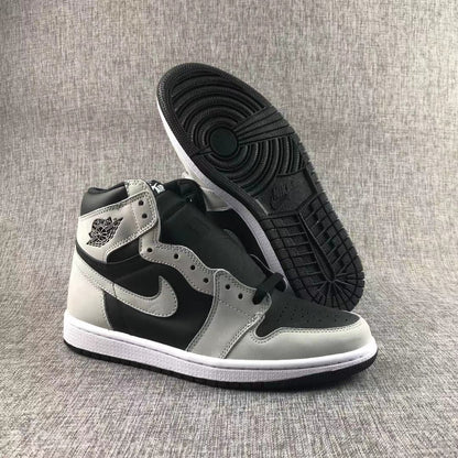 High-top sneaker displayed with one shoe lifted to reveal the black patterned outsole.