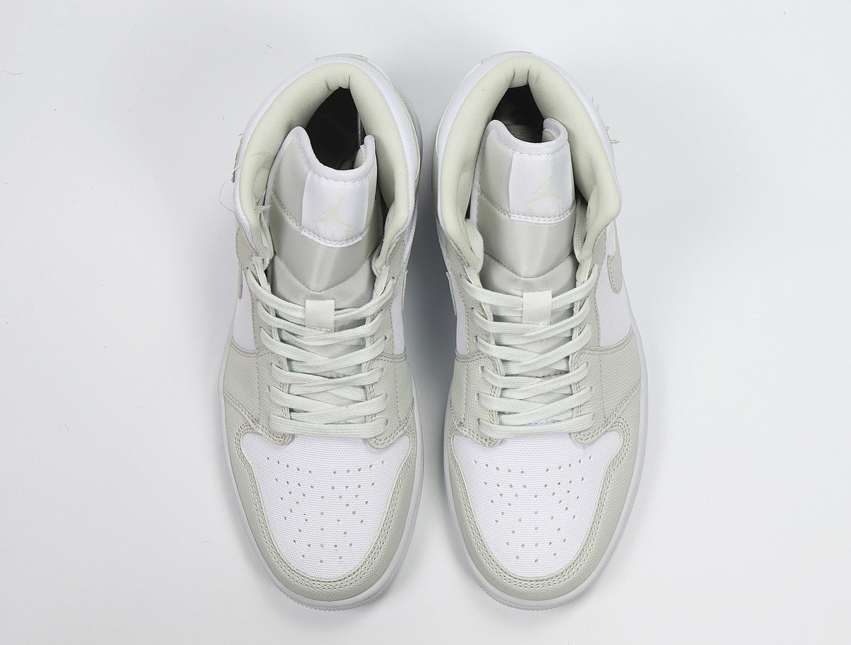 Top view of the pair showing white perforated toe panels, light Spruce overlays, and matching laces.
