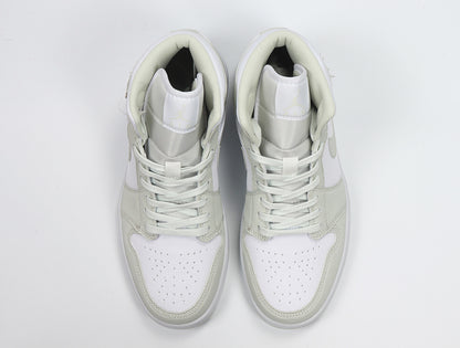 Top view of the pair showing white perforated toe panels, light Spruce overlays, and matching laces.