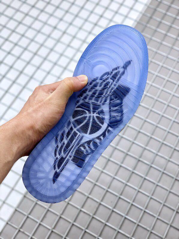 Translucent blue outsole shown from below with molded tread patterns.