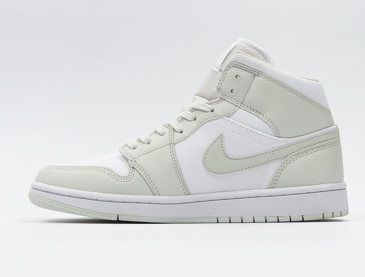 Side profile showing the high-top collar, Swoosh, layered panels, and white midsole.