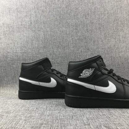 Pair of black and white mid-top sneakers displayed side by side.