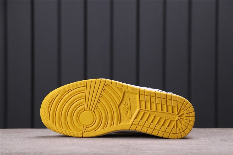 Underside view showing the yellow rubber outsole and circular traction pattern.