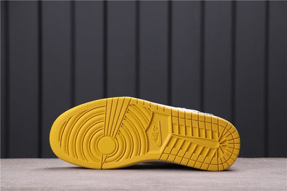 Underside view showing the yellow rubber outsole and circular traction pattern.