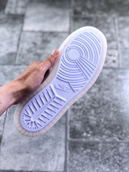 Underside view showing the sneaker’s white and translucent-tinted rubber tread pattern.