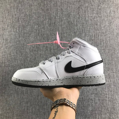 Side view of a white and black high-top Jordan sneaker with grey laces and a speckled grey midsole.