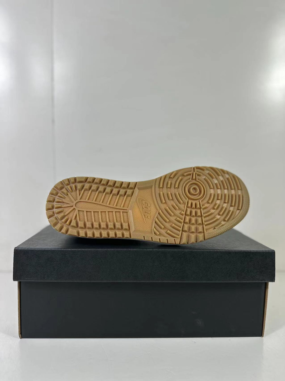 Close view of the gum-colored outsole with its circular and segmented traction pattern.