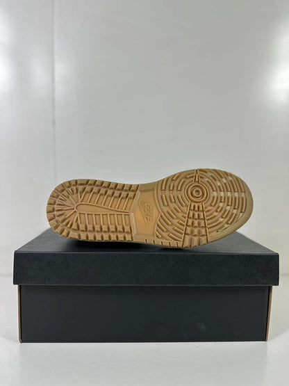 Close view of the gum-colored outsole with its circular and segmented traction pattern.