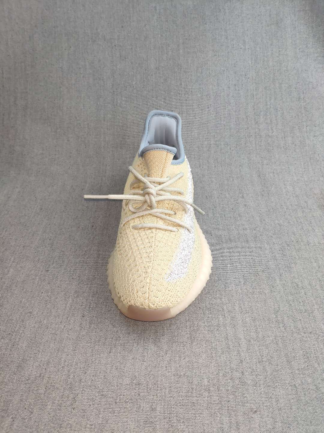 Top view showing the knit-style upper, laces, and reflective side detail.
