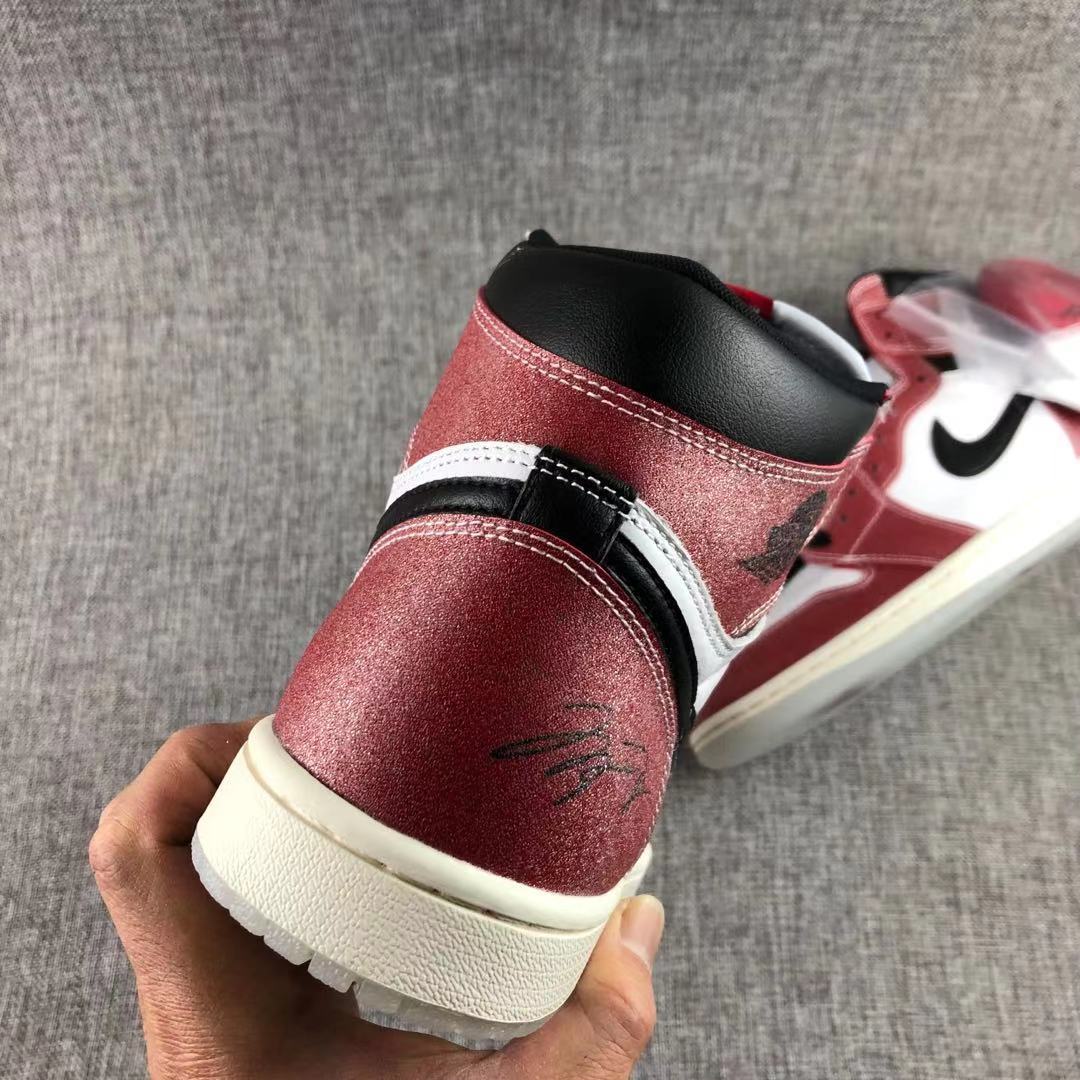 Close-up of the red heel and black padded collar on the high-top sneaker.