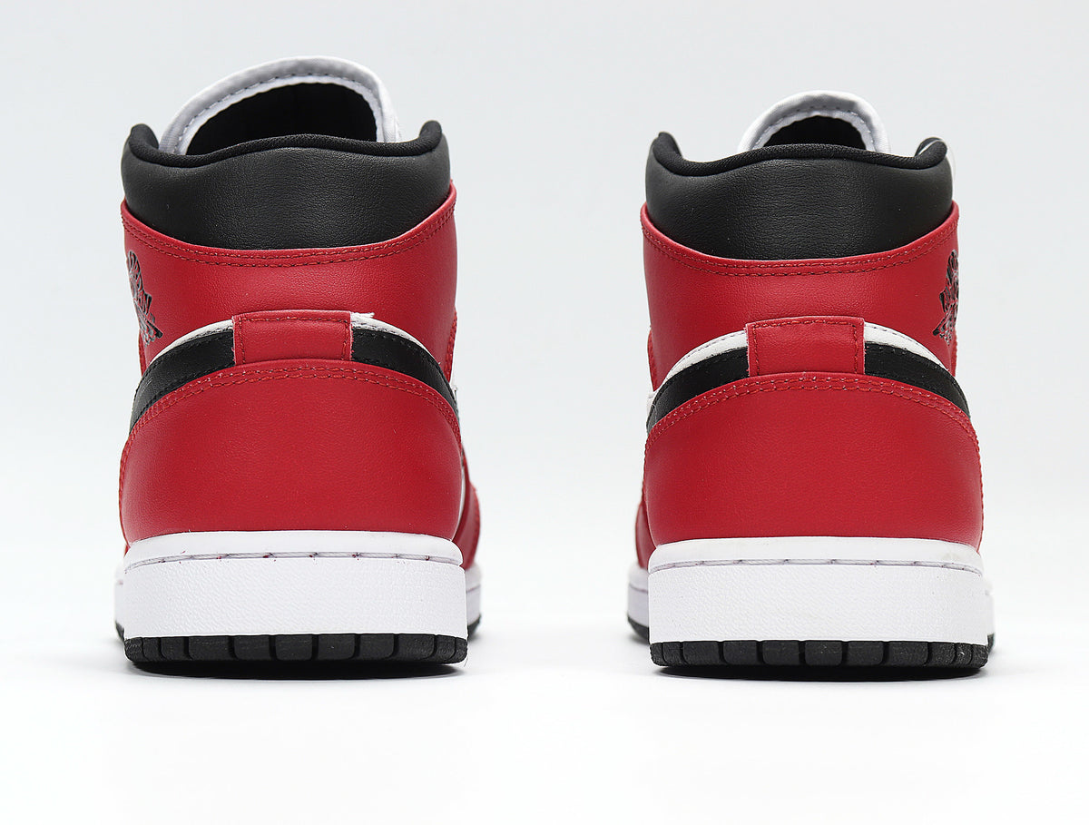 Rear view showing the red heel panels, black collars, white midsoles, and black outsoles
