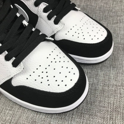 Close-up of the perforated white toe panel and black laces