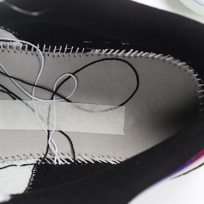 Close-up of the sneaker interior showing gray lining, black trim, and visible stitching.