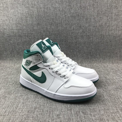Three-quarter front view of the pair with white laces and green collars.
