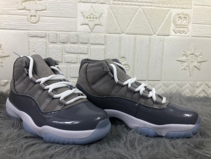 Pair of cool grey and black high-top sneakers shown from the side with white laces and white midsoles.