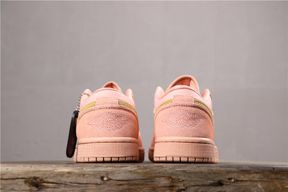 Rear view of the coral pink sneaker pair showing matching heel panels, stitched branding, and treaded rubber outsoles.