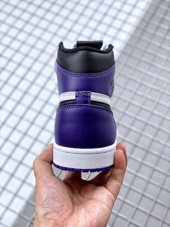 Rear view showing the purple heel, white midsole, and black padded collar.