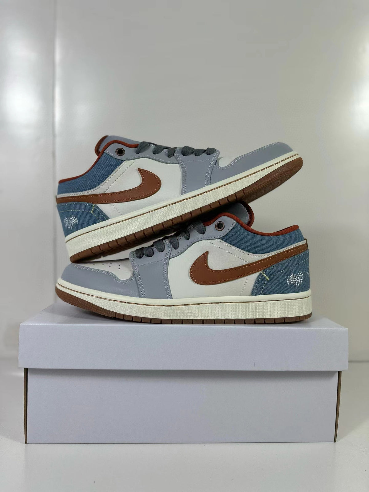 Pair of blue and gray Air Jordan 1 Low sneakers shown from the sides