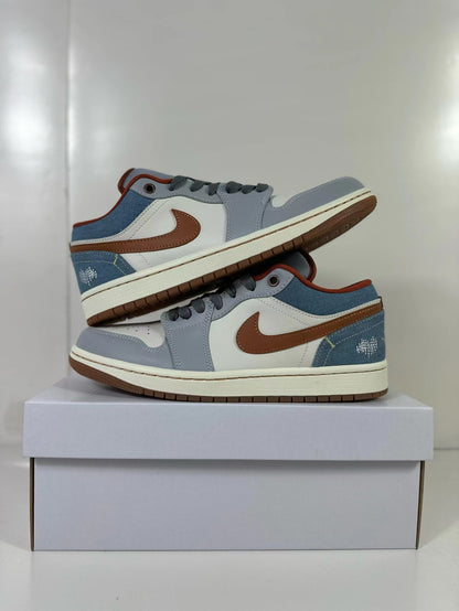 Pair of blue and gray Air Jordan 1 Low sneakers shown from the sides