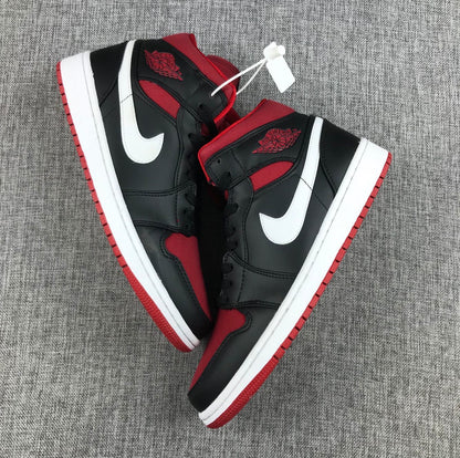 Overhead view of the matching pair showing black uppers, red panels, white Swooshes, and red outsoles.