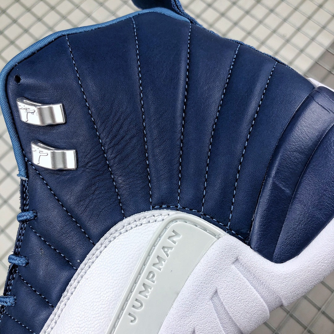 Close-up of the dark indigo stitched upper, metallic lace hardware, and raised Jumpman side-panel detail.