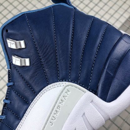 Close-up of the dark indigo stitched upper, metallic lace hardware, and raised Jumpman side-panel detail.