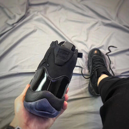 Rear view of a black high-top sneaker showing the padded collar and translucent heel outsole.