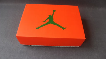 Orange Jordan shoe box with a dark green Jumpman logo on the lid.