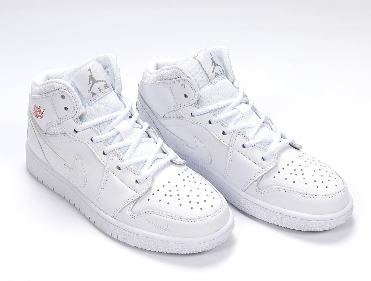 Angled front view of white high-top sneakers with white laces, perforated toes and layered side panels.