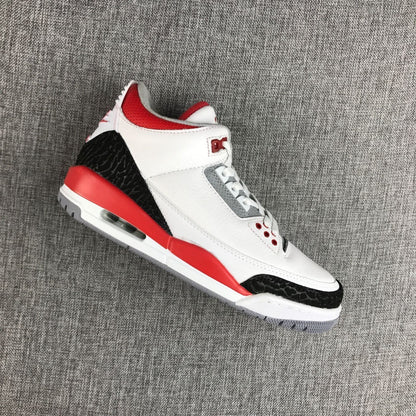 Angled view showing the white upper, gray lace panel, red accents, and black textured overlays.
