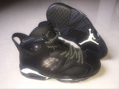 Side view of a black Jordan 6 sneaker beside its outsole, showing the high-top shape and circular traction pattern.