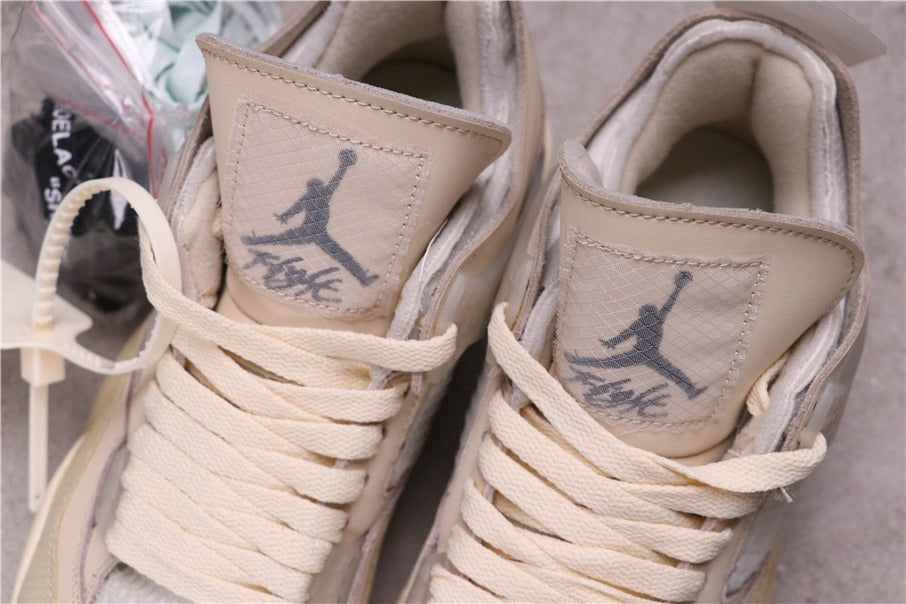 Close-up of the tongues showing Jumpman-style graphics, printed lettering, cream laces, and padded collars.