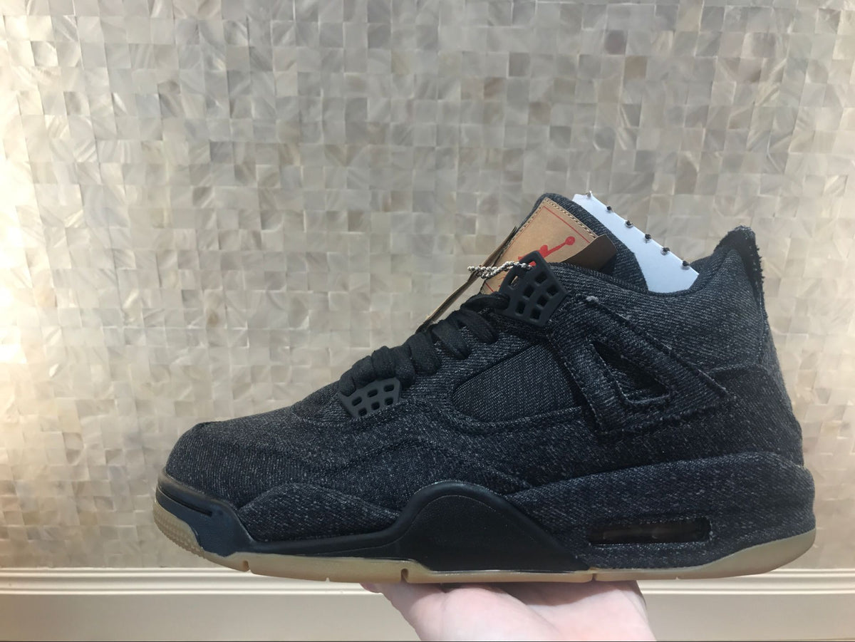 Full side profile of the black denim-style high-top sneaker.