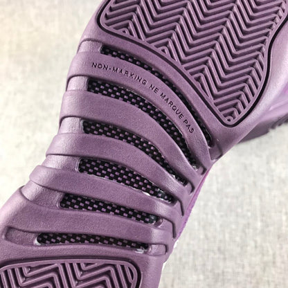 Close-up of the purple outsole with patterned tread and non-marking text