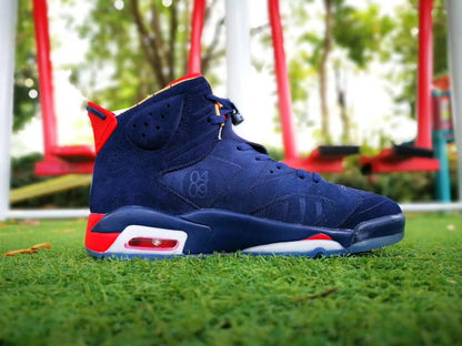 Side profile of a navy high-top sneaker with red heel accents and a white midsole air unit.