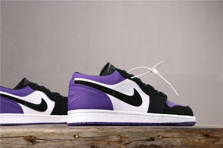 Profile view of the purple, white, and black low-top sneaker with a white midsole and purple outsole.