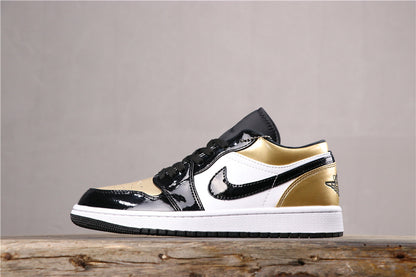 Side profile showing the black toe and overlays, white quarter panel, black Swoosh, and metallic gold heel and collar accents.