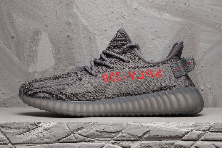 Profile view highlighting the dark grey upper, black patterning, red side lettering and translucent outsole.
