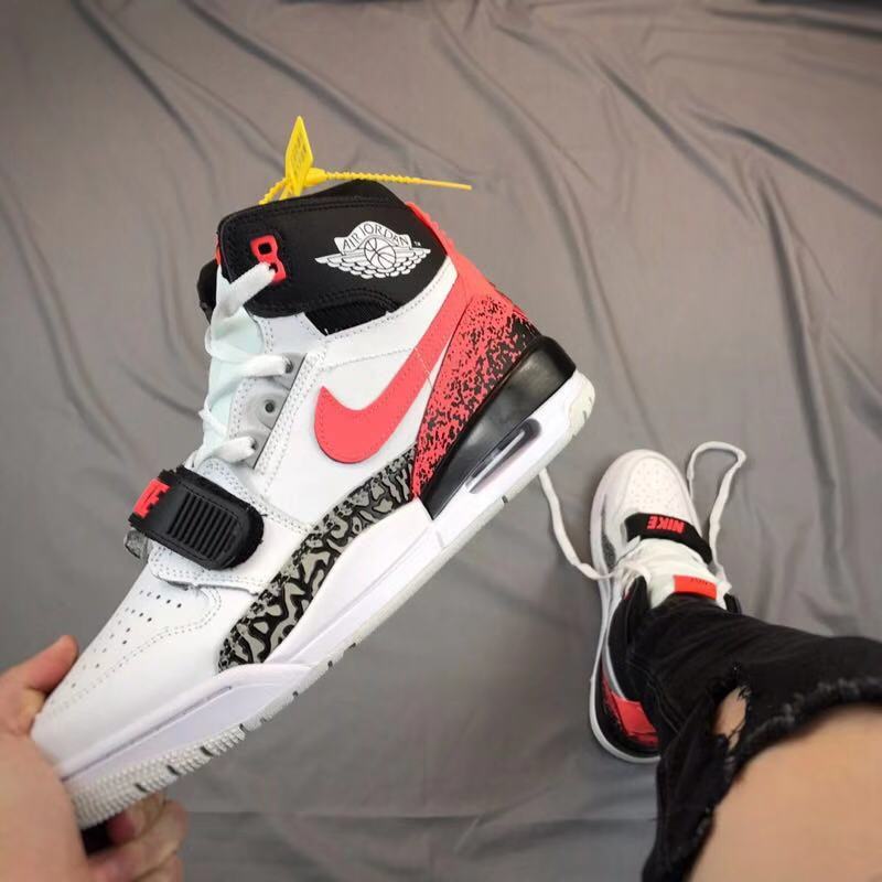 Front three-quarter view showing the high-top collar, forefoot strap, red side Swoosh, and patterned side panel.