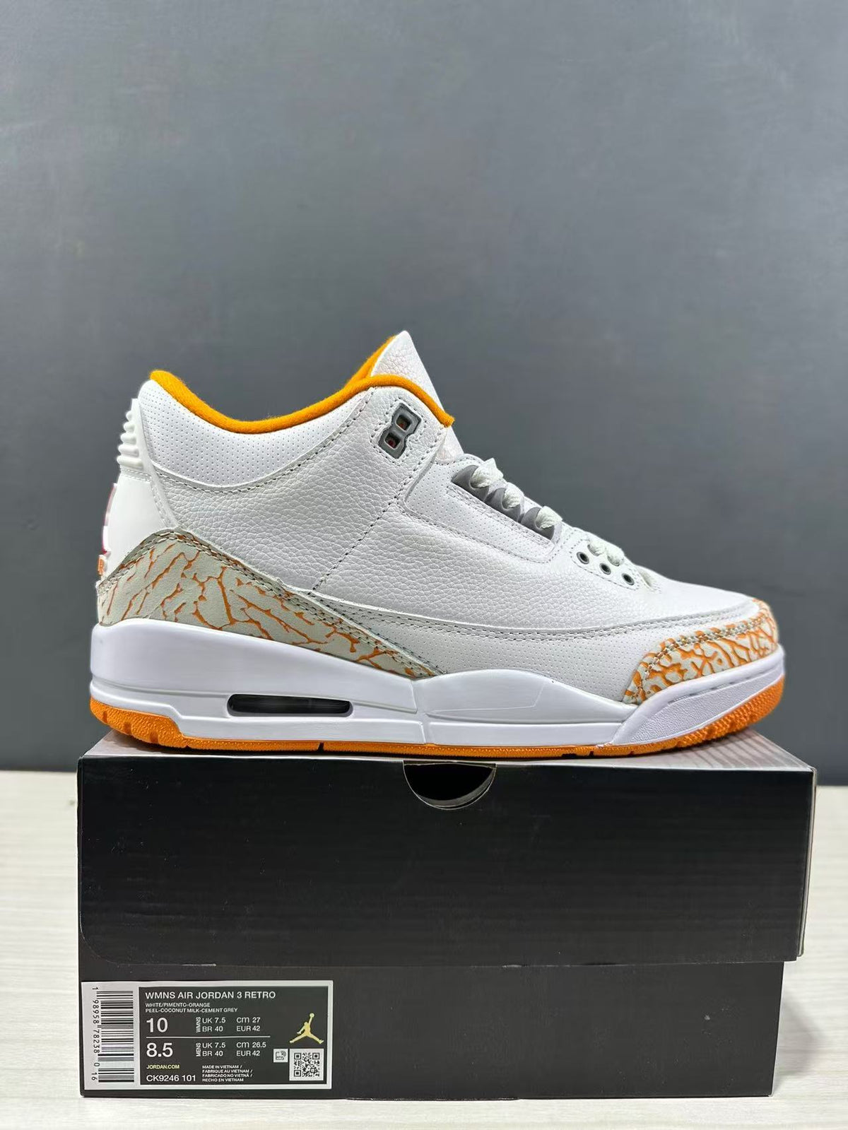 Close side view of the sneaker above its box; the box label identifies the women's Air Jordan 3 Retro, style CK9246 101, with sample size EU 42.