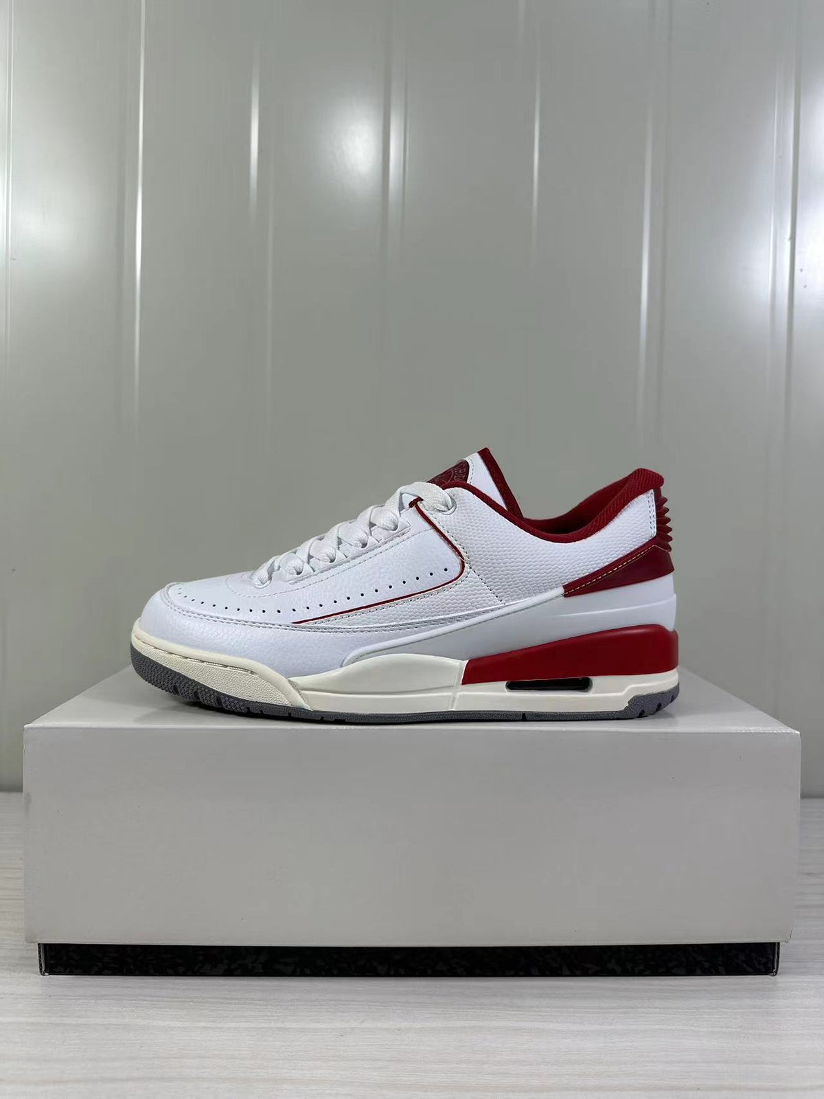 Opposite side profile showing the white upper, red heel trim, and contrasting gray outsole.