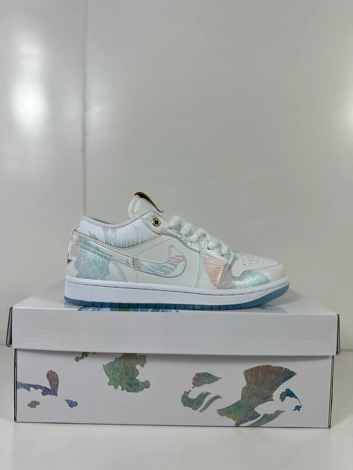 Side profile of a white low-top sneaker with pastel panels and a translucent blue outsole.