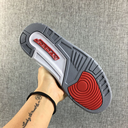 Underside of the sneaker showing a gray outsole with red details.