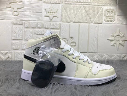 Side profile of a cream and white mid-top sneaker with black detailing and a clear bag containing an extra black lace accessory.